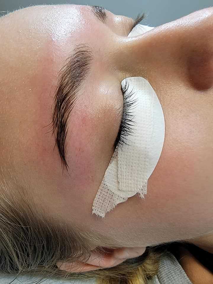 Close-up of a person with eye patches and gauze on eyelids, possibly during a beauty treatment.